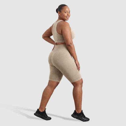 Woman wearing Sculpt 3D™ anti-cellulite shorts in beige, side view, showing the 3D sculpt lines