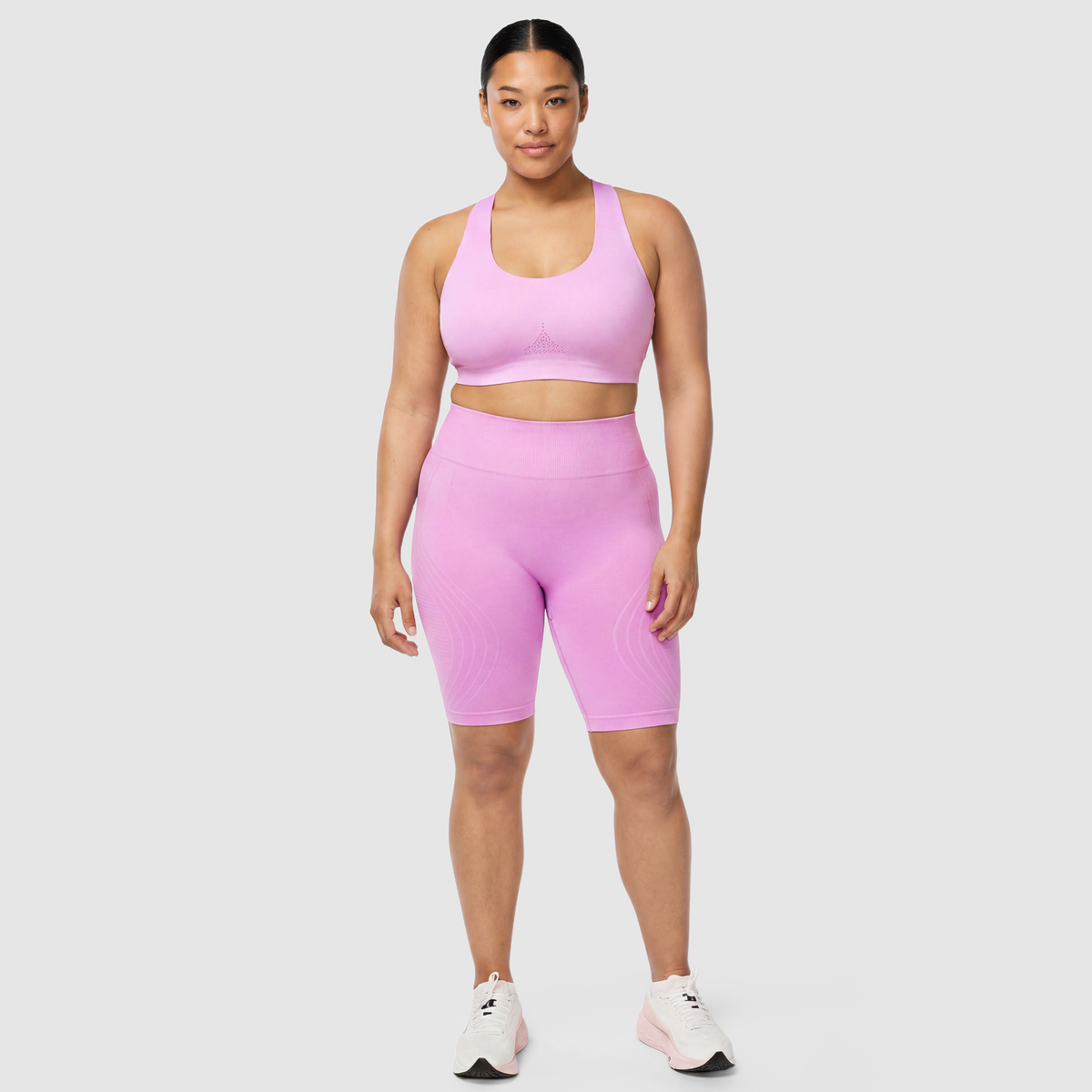 Woman wearing Sculpt 3D™ anti-cellulite shorts in pink, front view, high-waisted fit