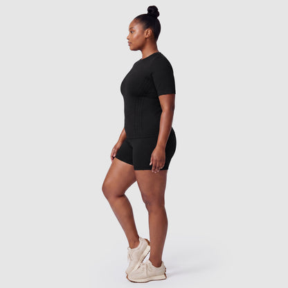Woman wearing the Sculpt 3D™ compression tee in black, side view