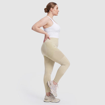 Woman wearing Sculpt 3D™ anti-cellulite leggings in beige, side view, showing the 3D sculpt lines