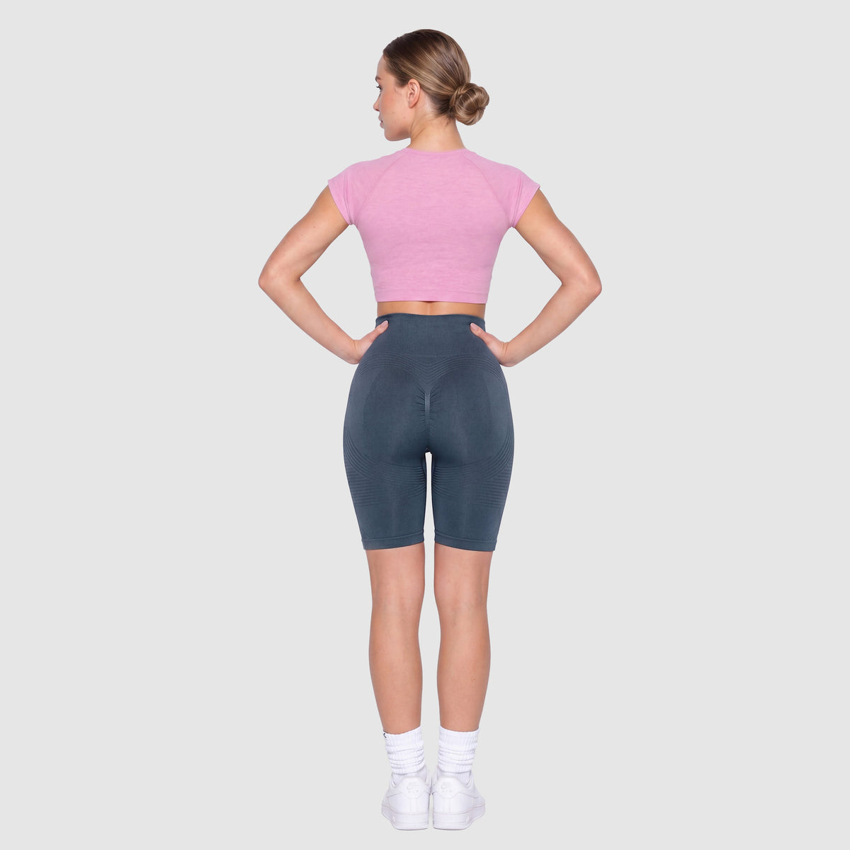 Woman wearing Sculpt 3D™ anti-cellulite shorts in navy blue, back view, lifted, contoured rear