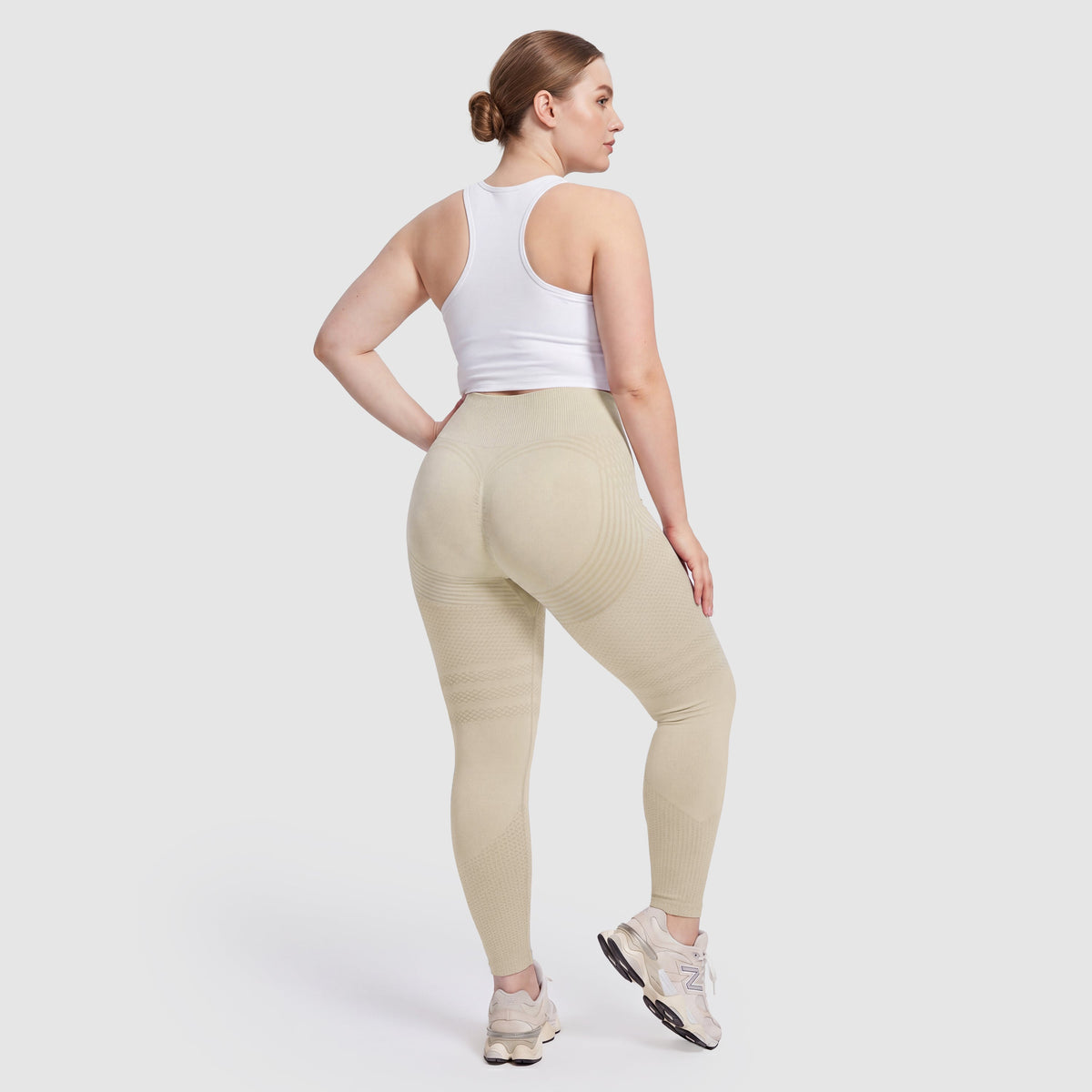 Woman wearing Sculpt 3D™ anti-cellulite leggings in beige, back view, lifted, contoured rear