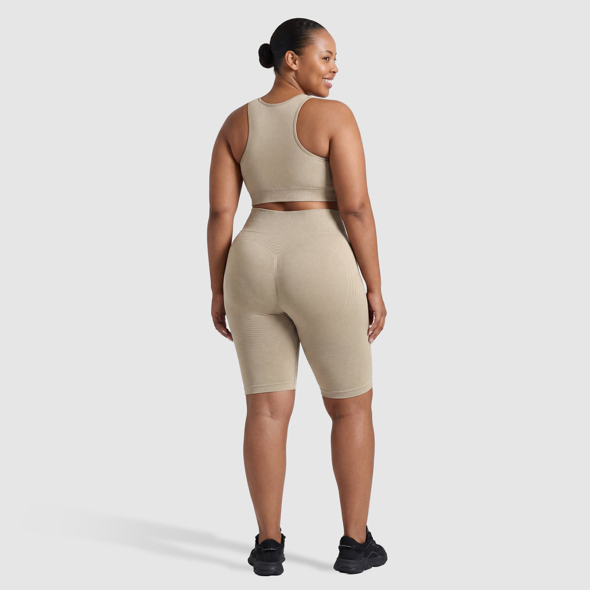 Woman wearing Sculpt 3D™ anti-cellulite shorts in beige, back view, lifted, contoured rear