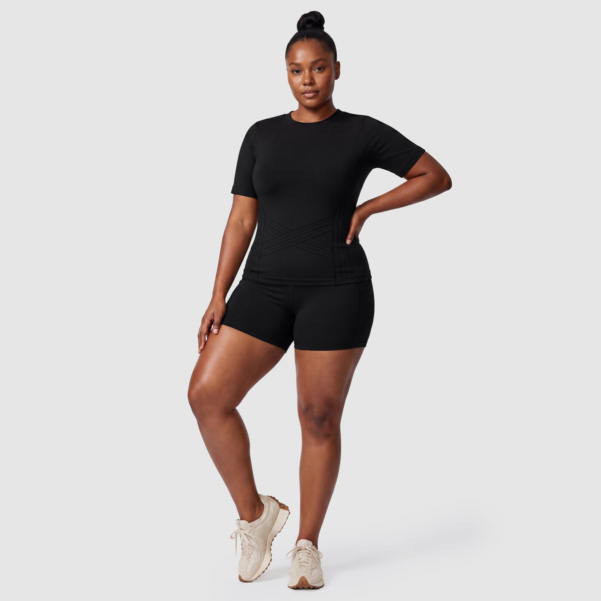 Woman wearing the Sculpt 3D™ compression tee in black, front view