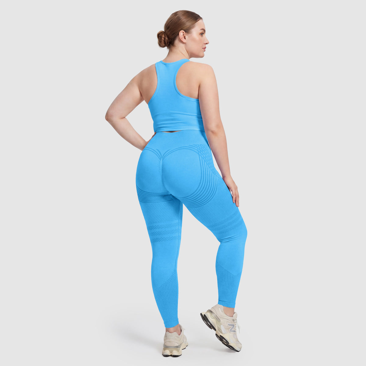Woman wearing Sculpt 3D™ anti-cellulite leggings in turquoise, back view, lifted, contoured rear