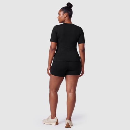 Woman wearing the Sculpt 3D™ compression tee in black, back view
