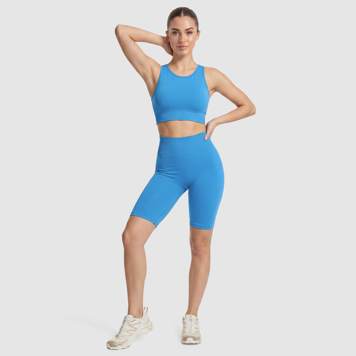 Woman wearing Sculpt 3D™ anti-cellulite shorts in turquoise, front view, high-waisted fit