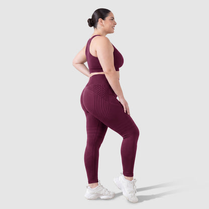 Woman wearing Sculpt 3D™ anti-cellulite leggings in plum, side view, showing the 3D sculpt lines