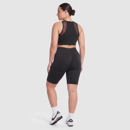 Woman wearing Sculpt 3D™ anti-cellulite shorts in black, back view, lifted, contoured rear