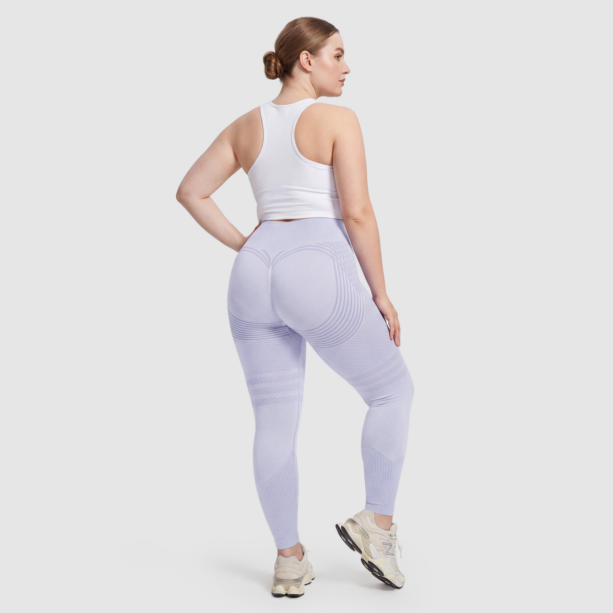 Woman wearing Sculpt 3D™ anti-cellulite leggings in light blue, back view, lifted, contoured rear