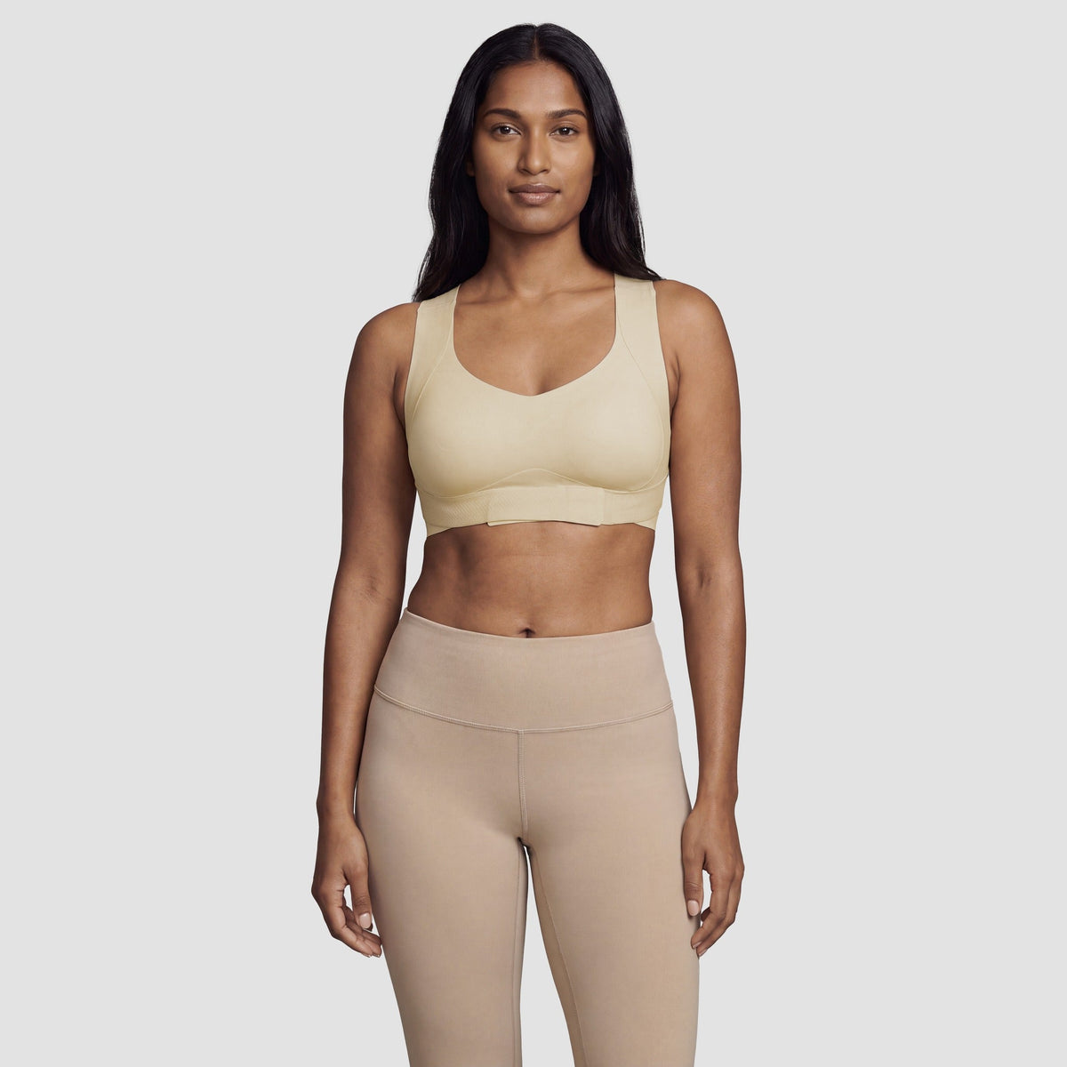 Woman wearing the Sculpt wireless posture bra in beige, front view