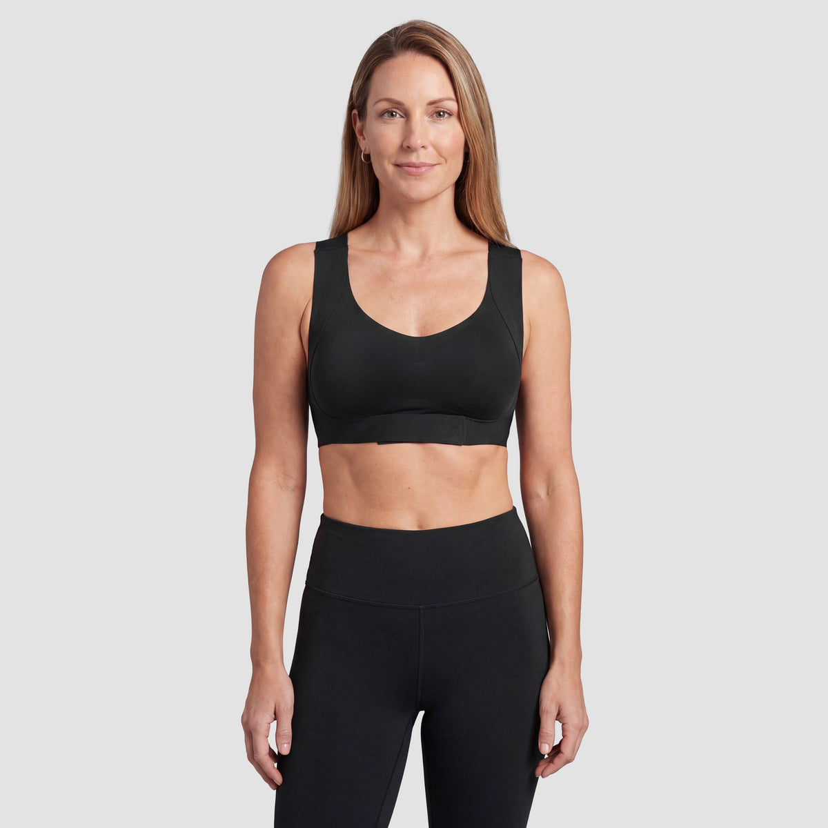 Woman wearing the Sculpt wireless posture bra in black, front view