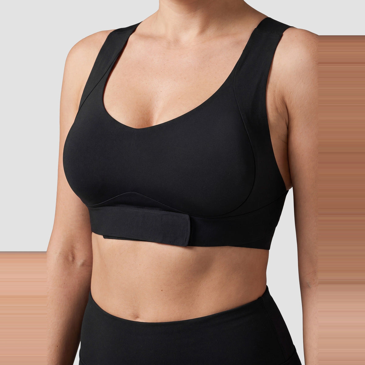 Close-up of the front-closure band on the Sculpt posture bra in black