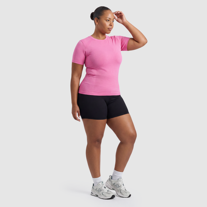 Woman wearing the Sculpt 3D™ compression tee in pink, three-quarter view