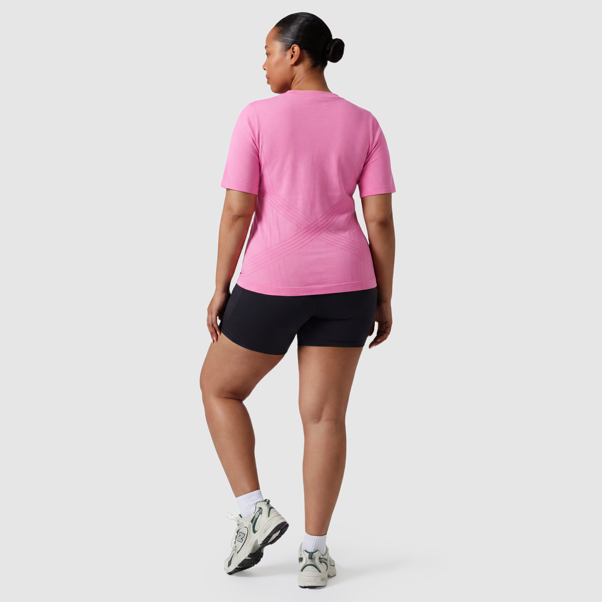 Woman wearing the Sculpt 3D™ compression tee in pink, back view