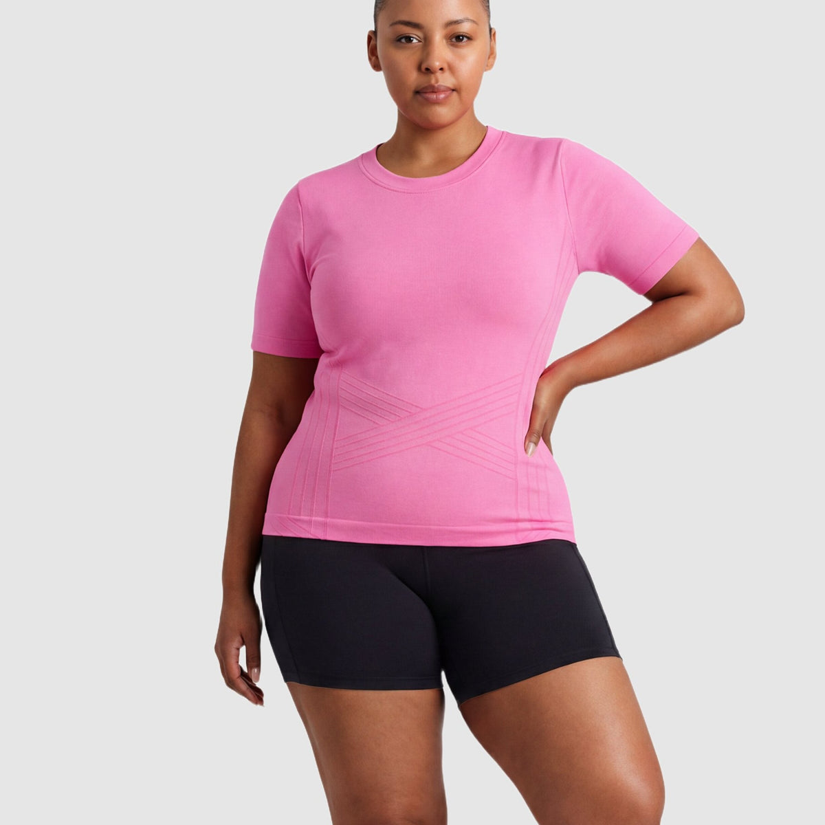 Woman wearing the Sculpt 3D™ compression tee in pink, front view